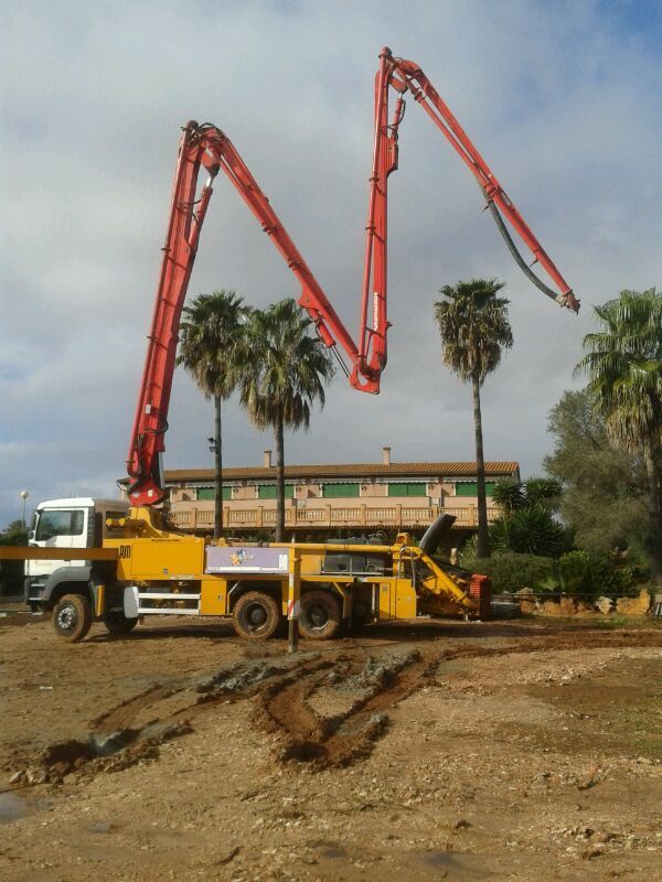 Un camión amarillo con una grúa roja adjunta.