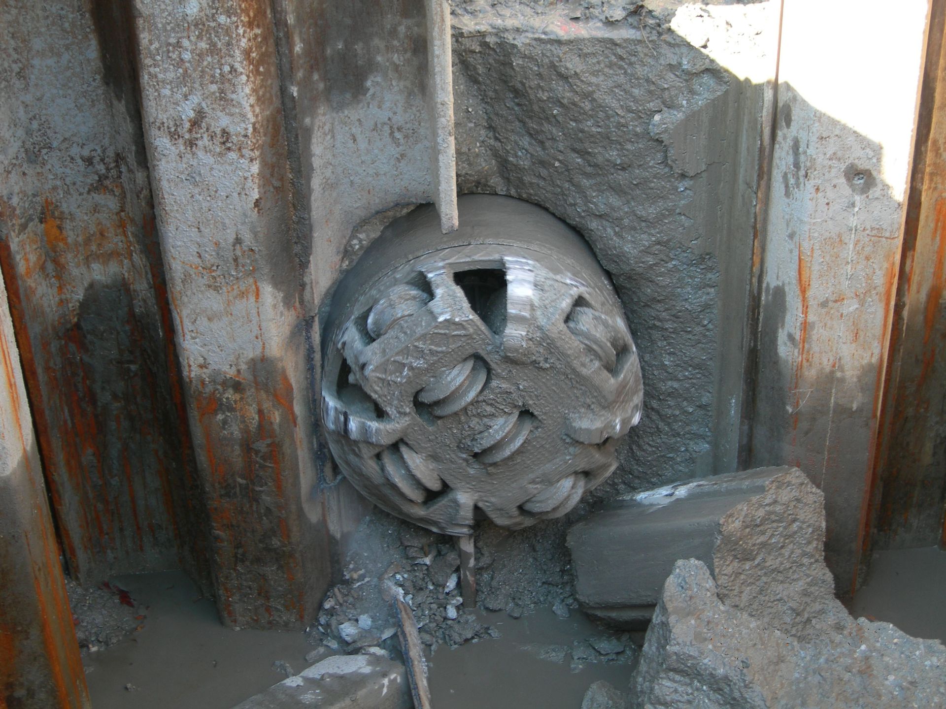 Un gros objet métallique se trouve dans un trou dans le sol.