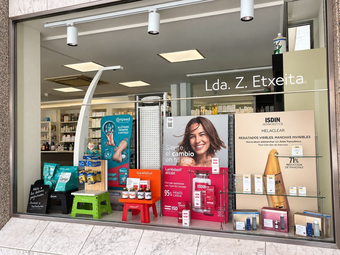 Escaparate de tienda con productos para mascotas, carteles coloridos y un póster sonriente en el exterior.