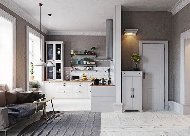 Una sala de estar con un sofá, una mesa y una cocina.