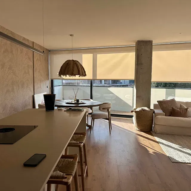 Una sala de estar con un sofá, una mesa y sillas.