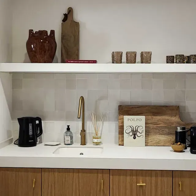 Una cocina con un fregadero y una tabla de cortar