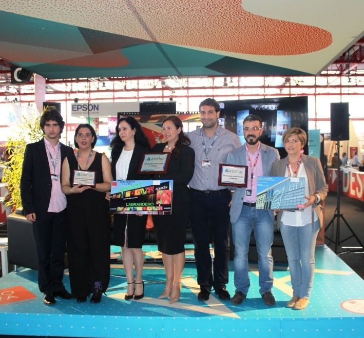 Un grupo de personas de pie frente a un cartel de Epson.