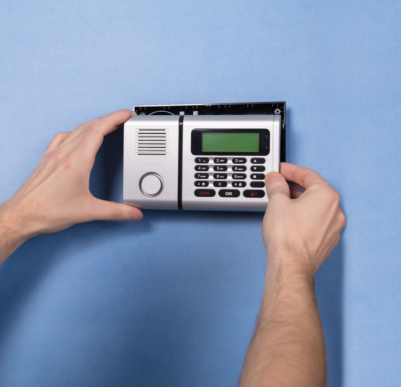Des panneaux solaires installés sur un toit blanc, avec un arbre en arrière-plan sous un ciel bleu.
