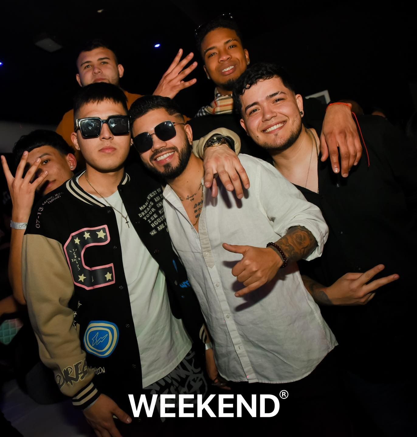 Un grupo de jóvenes posando para una foto con la palabra fin de semana escrita en la parte inferior.