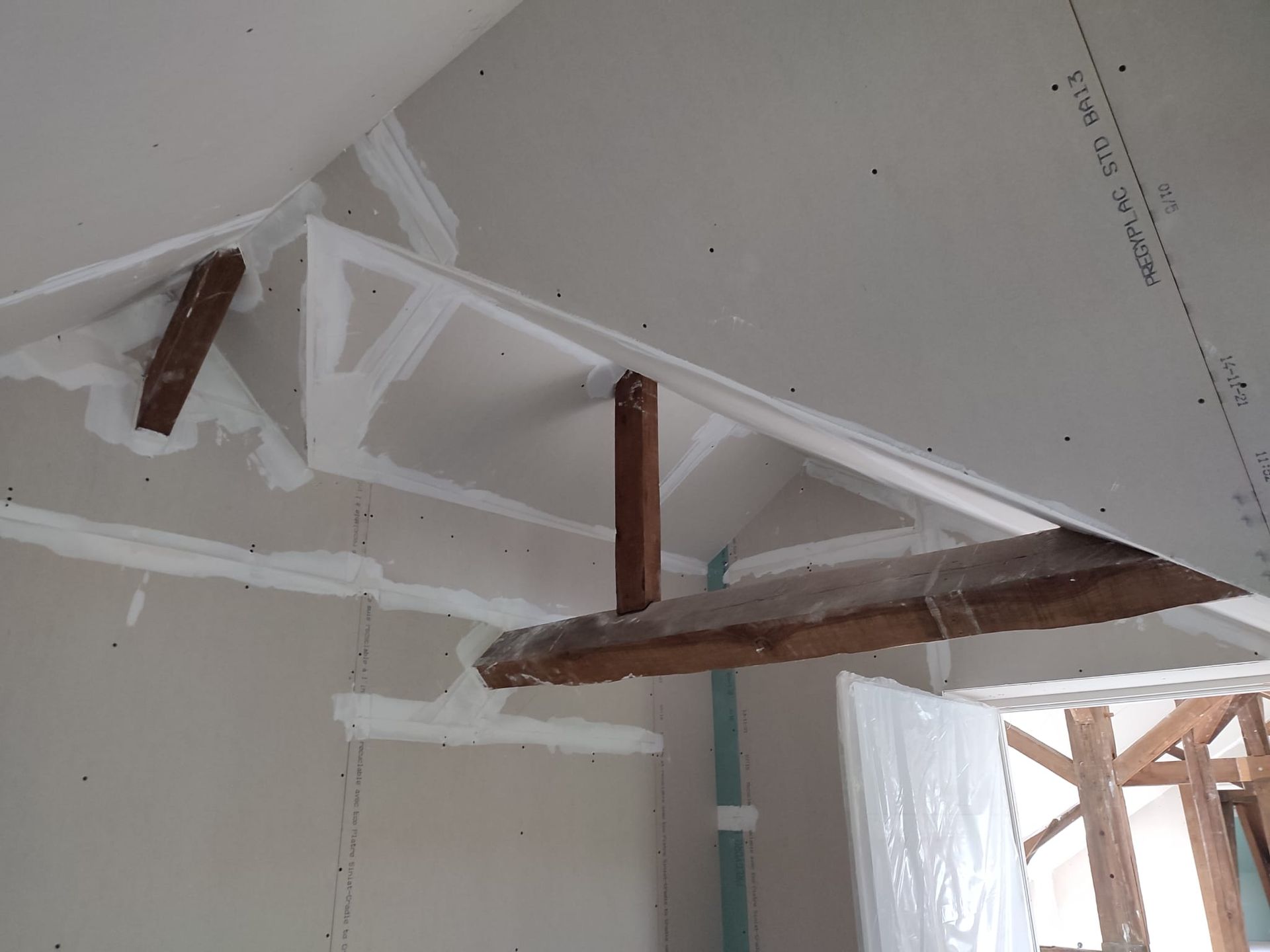 Un plafond avec une poutre en bois