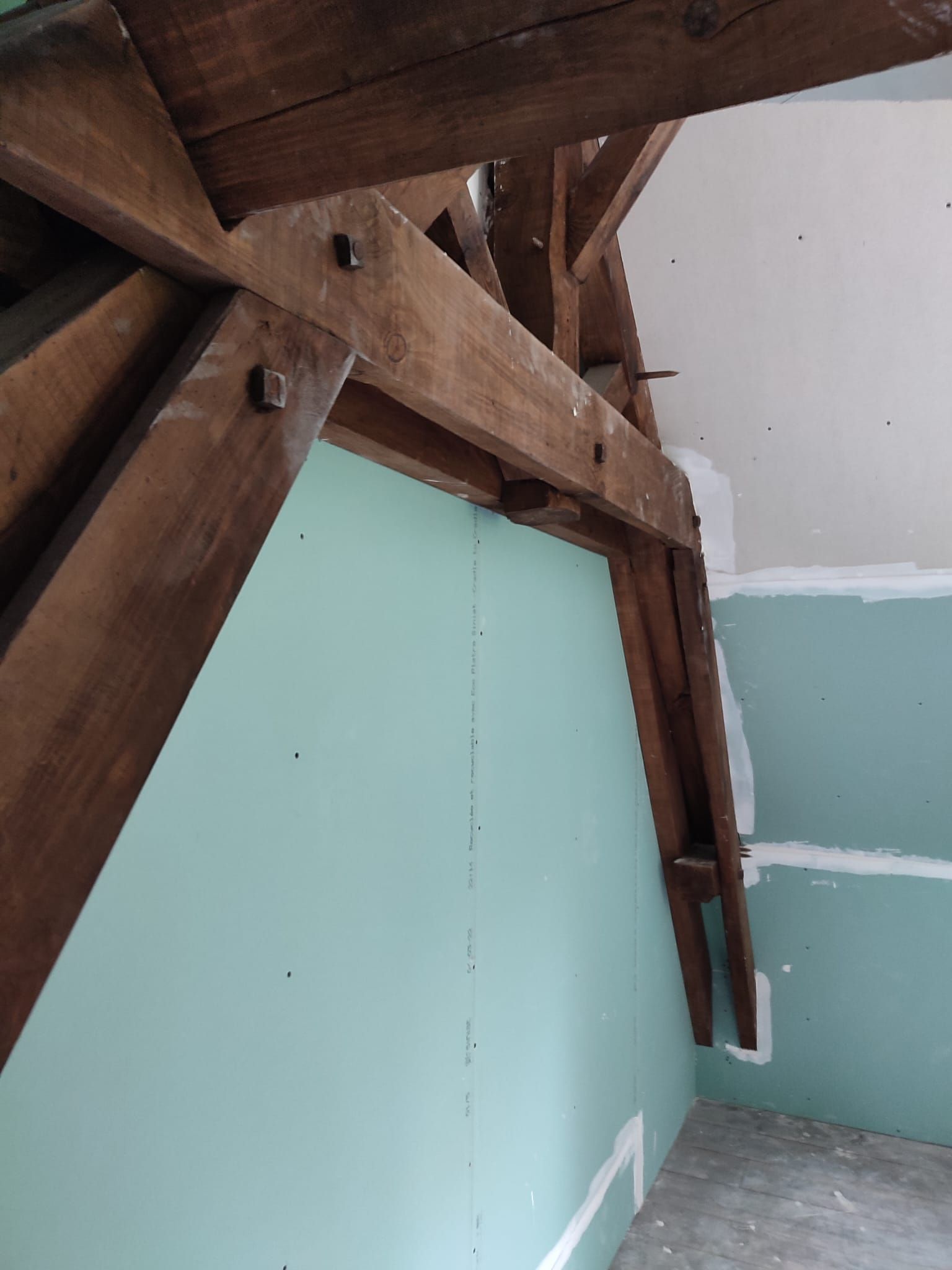 Un mur bleu à gauche avec la partie supérieure en bois