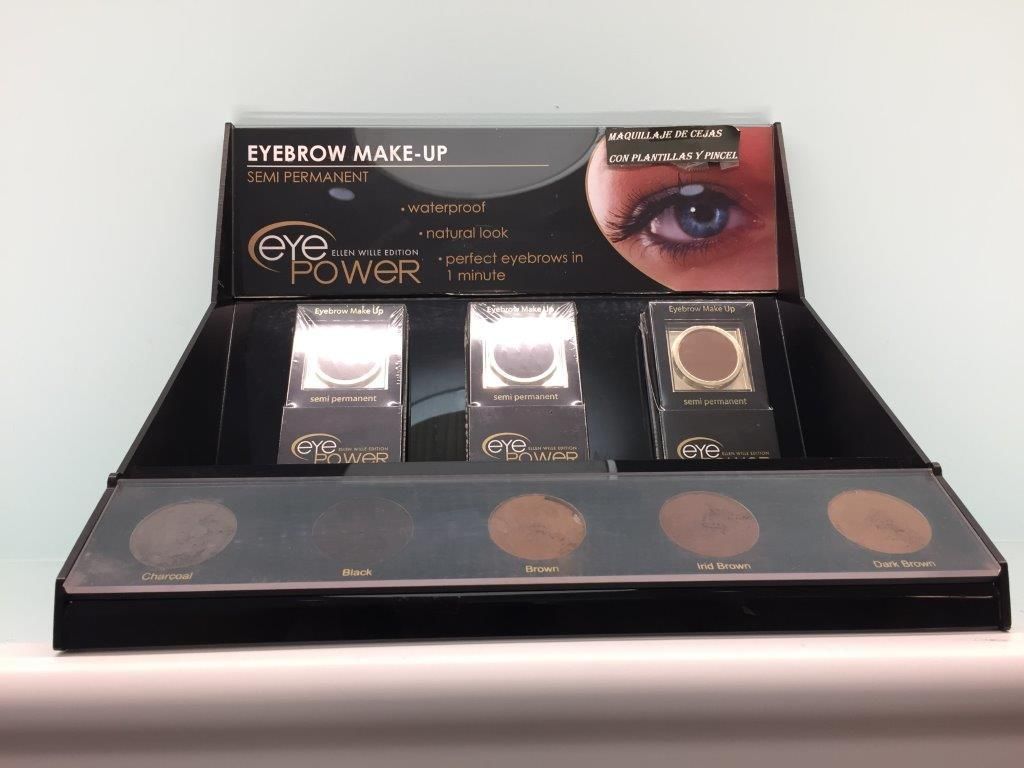 Una exhibición de maquillaje de cejas colocada encima de una mesa.