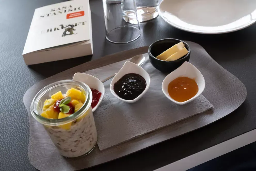 A tray of food and a book on a table