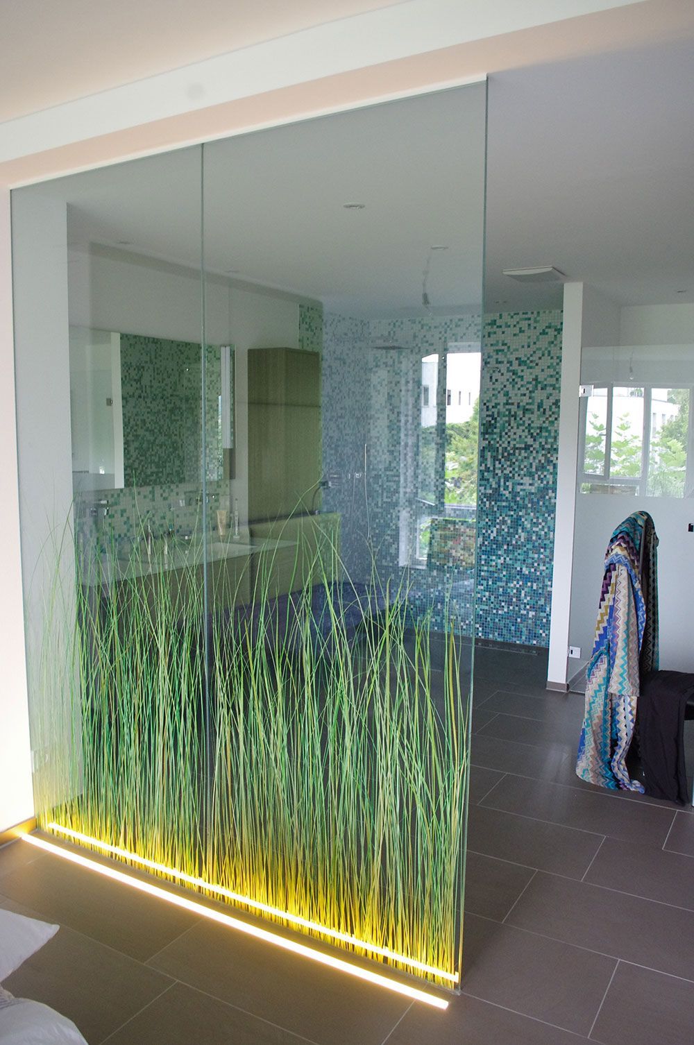 Eine Glaswand mit einem Bild von Gras darauf
