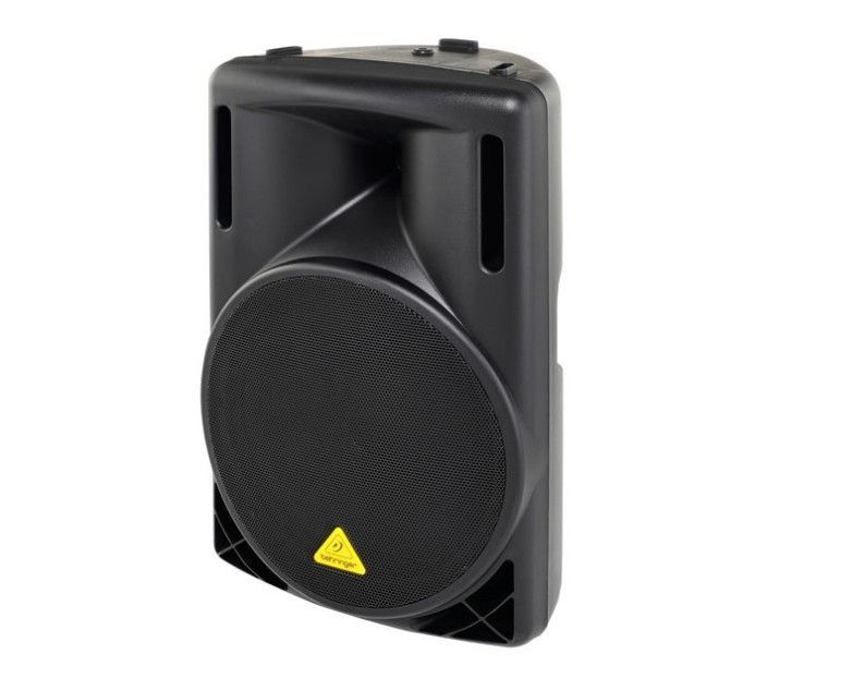 Altavoz Behringer negro con rejilla redonda y logotipo amarillo.