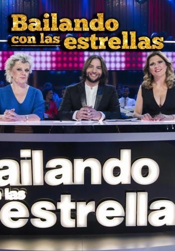 Man poses by an orange sign that reads 