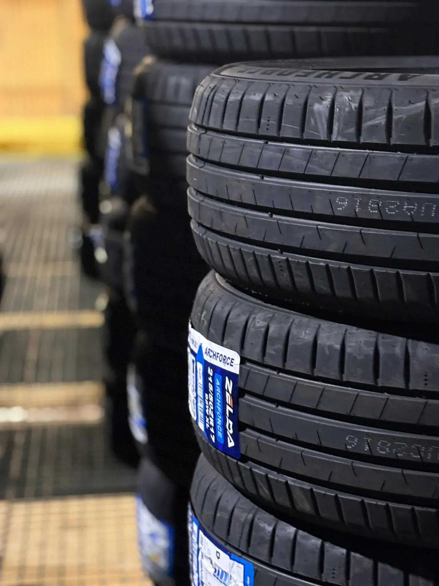 Pilas de neumáticos negros nuevos en un área de almacenamiento.