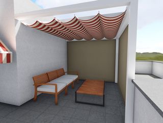 Un patio con un sofá y una mesa bajo un dosel.