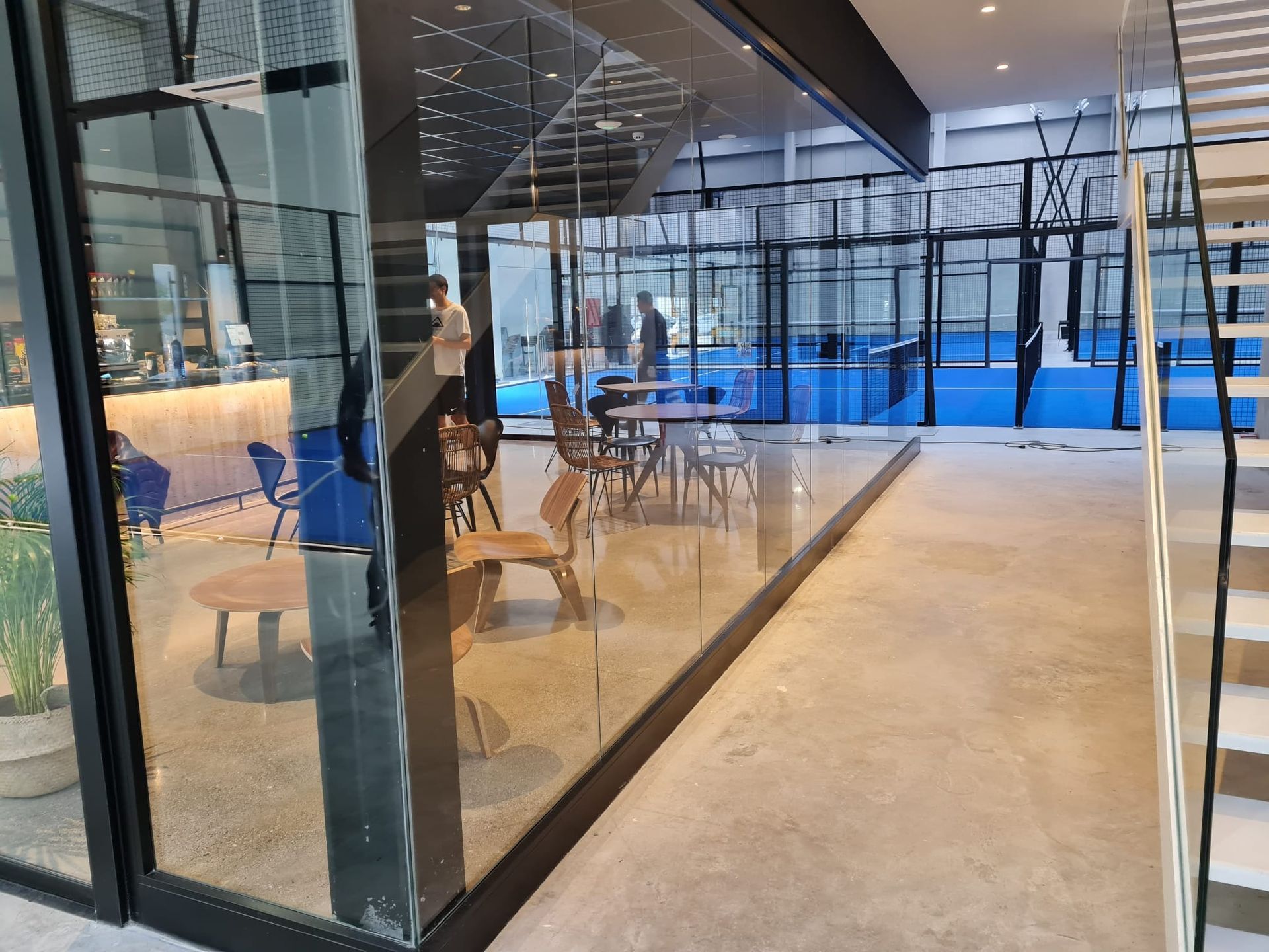 Una habitación con una pared de cristal y escaleras.