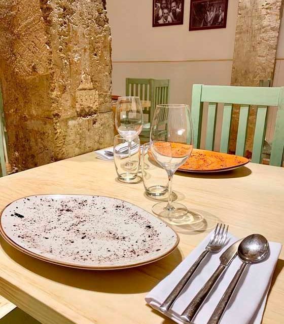 Una mesa con platos, vasos y cubiertos encima.