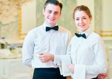 Un hombre y una mujer están parados uno al lado del otro en un restaurante.