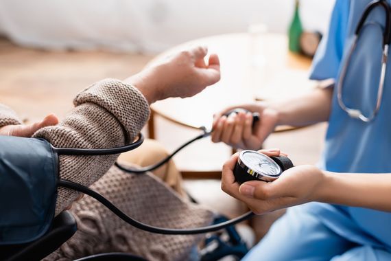 Un médecin prend la tension artérielle d'un patient à l'aide d'un tensiomètre.