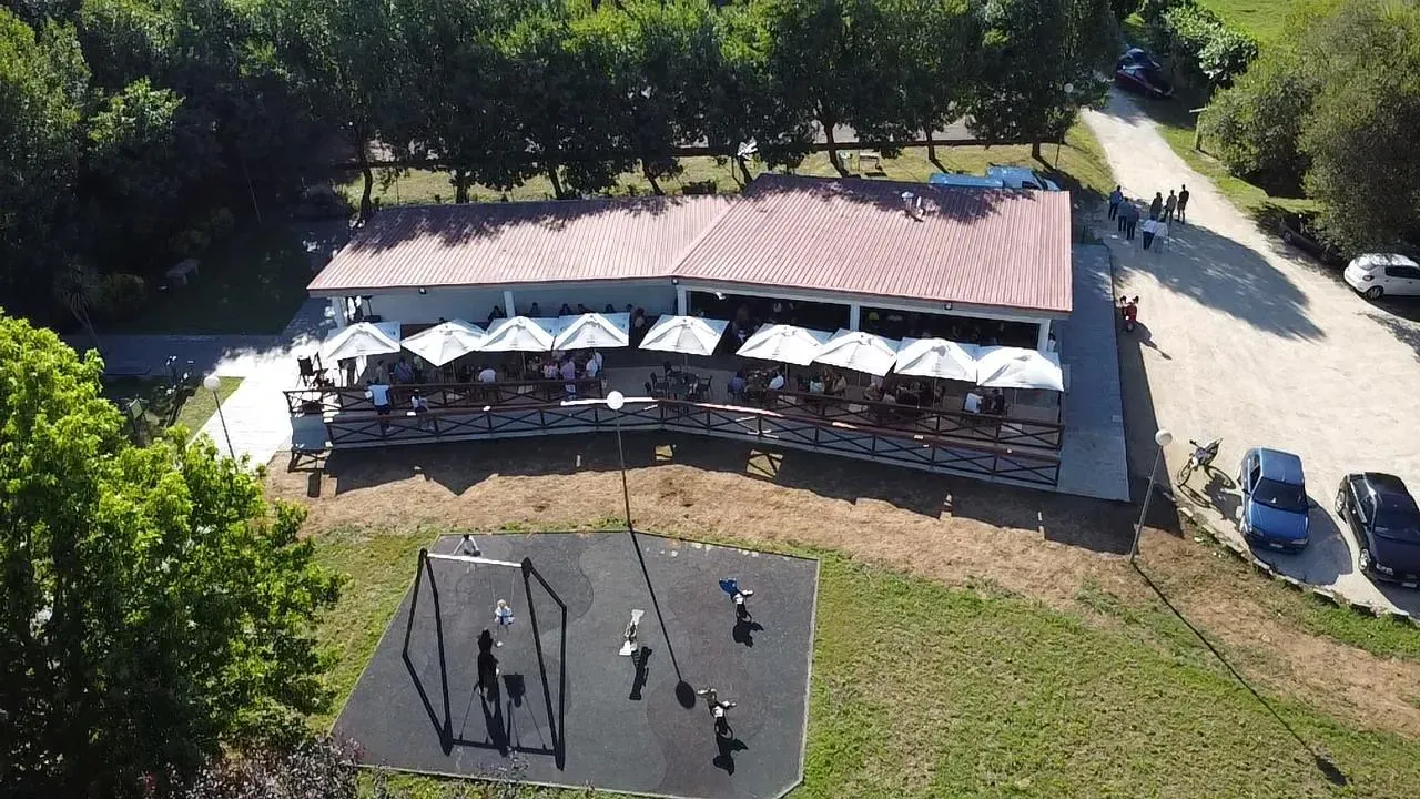 Una vista aérea de un restaurante con sombrillas y un parque infantil.