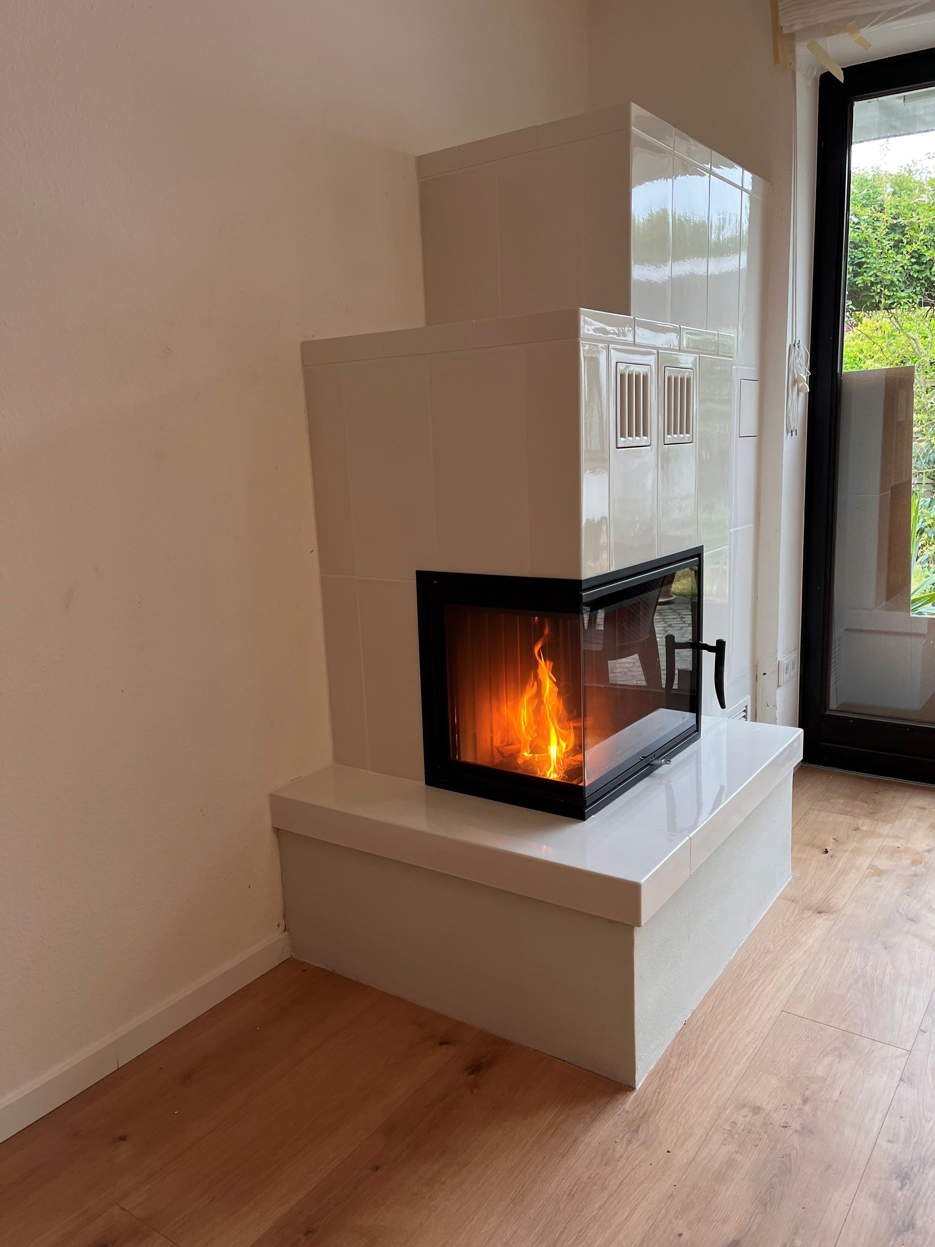 In der Ecke des Zimmers befindet sich ein Kamin.