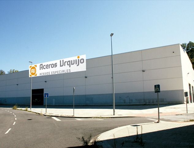 Un edificio blanco con un cartel que dice aceros urquijo