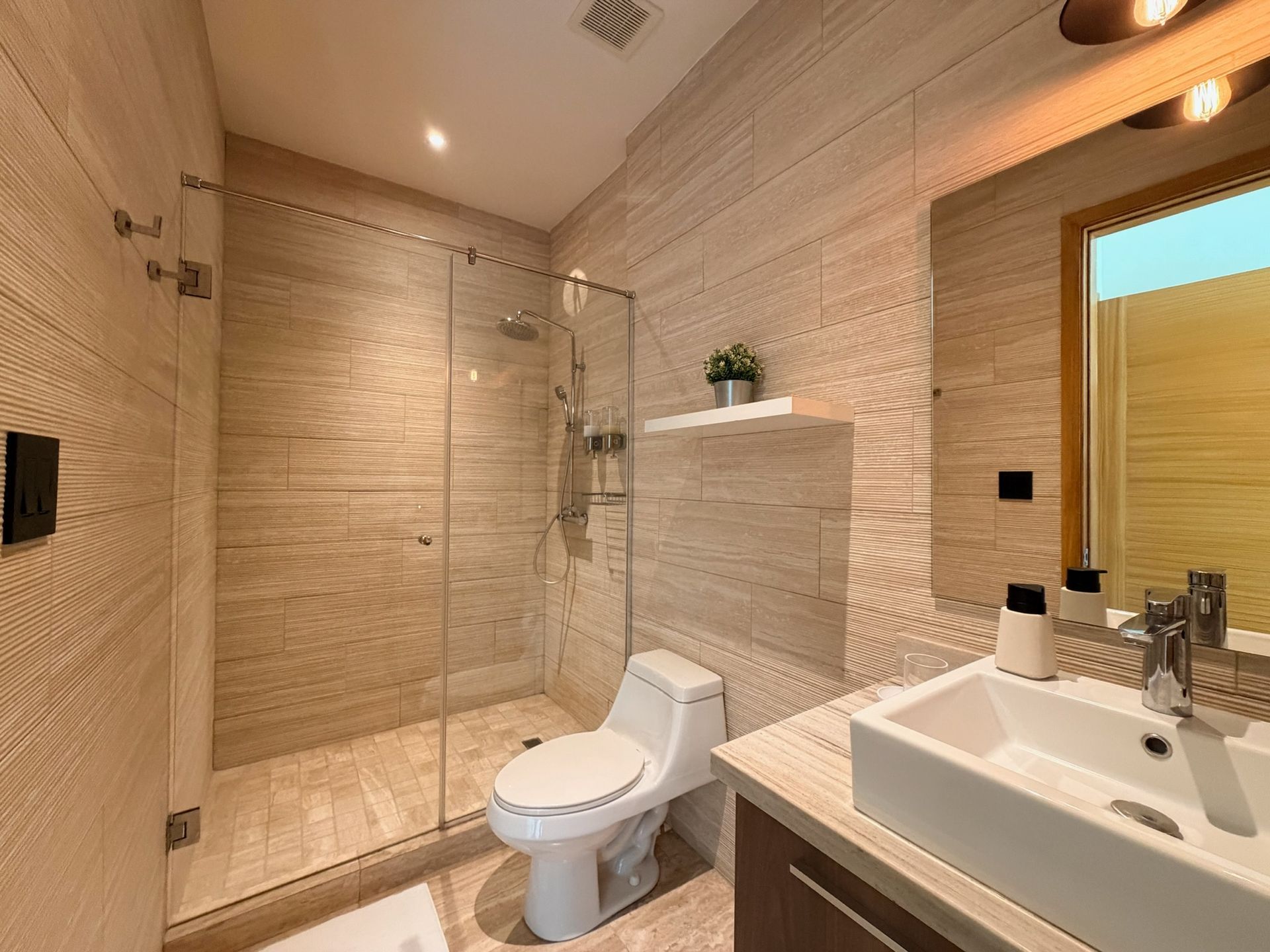 Modern spa-inspired bathroom Playa Escondida. Stone finishes and rain shower for a restorative experience 2