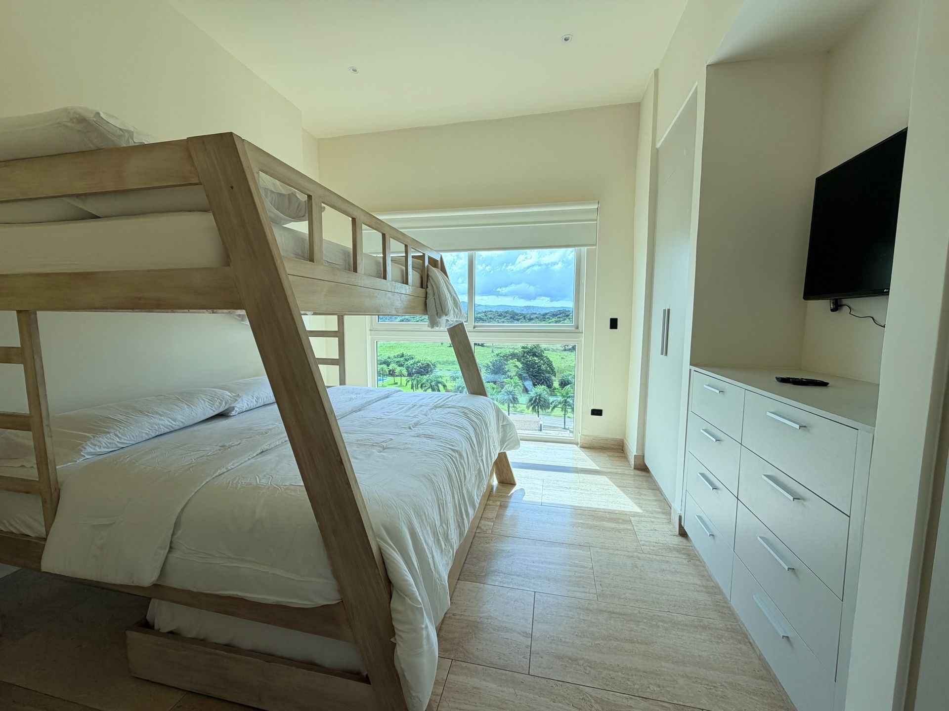 Playa Escondida guest residence. Spacious family room with handcrafted wooden bunk beds and natural light