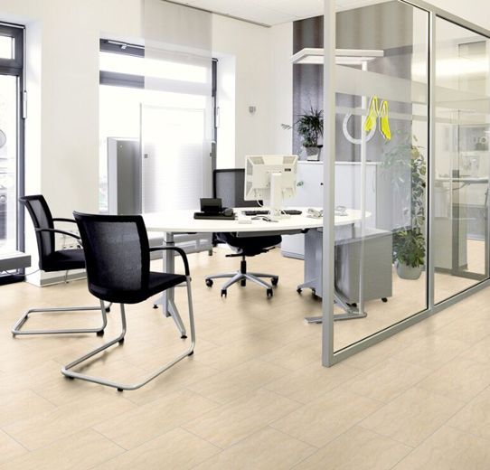 Ein Zimmer mit einem Schreibtisch und Stühlen und einer Glaswand