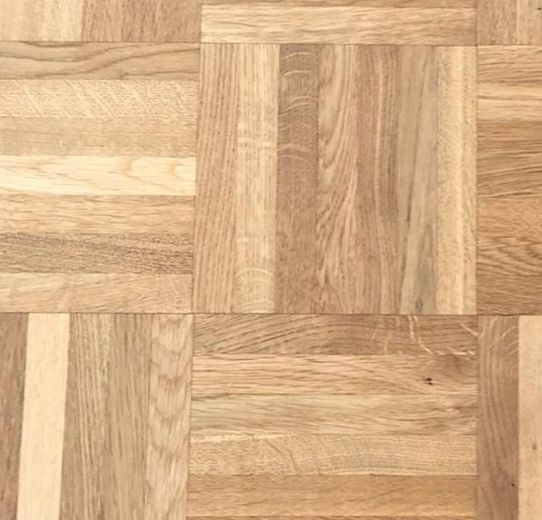 Eine Nahaufnahme eines Holzbodens mit Schachbrettmuster.