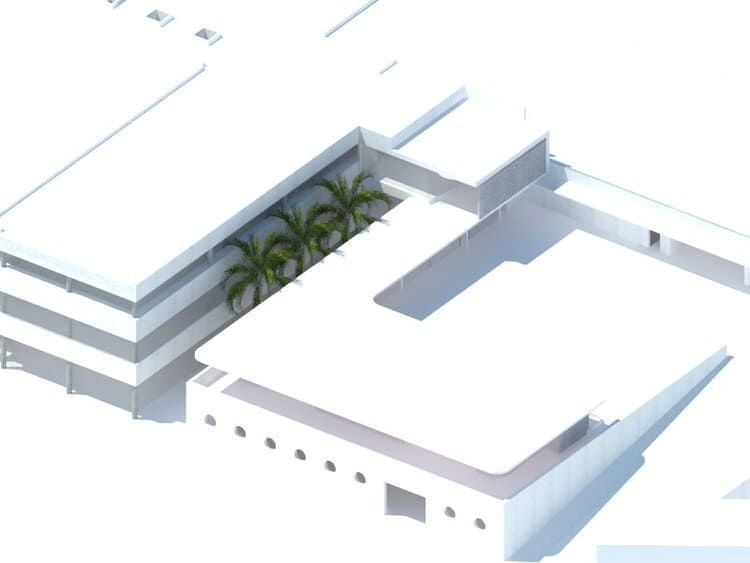 Una vista aérea de un edificio blanco con palmeras.