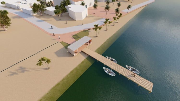 Una vista aérea de un muelle con barcos junto a un cuerpo de agua.