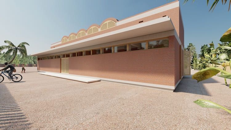 Un hombre va en bicicleta delante de un gran edificio.