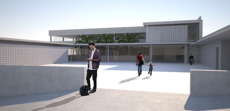 Un hombre con una mochila está parado frente a un edificio.