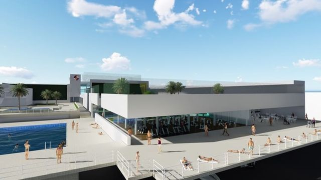 Impresión artística de un gran edificio junto a un cuerpo de agua.