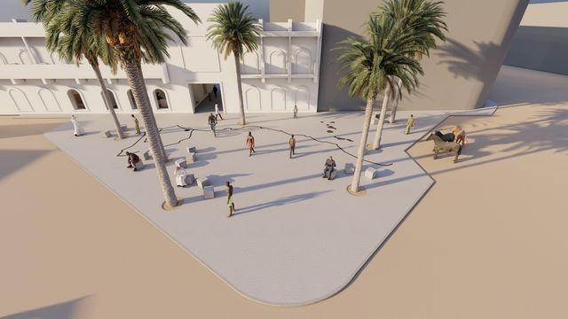 Una vista aérea de una plaza con palmeras frente a un edificio.