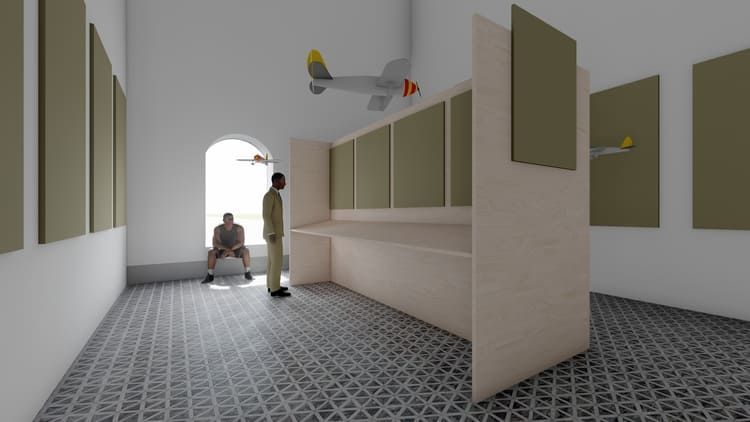 Un hombre está de pie en una habitación con un avión colgando del techo.