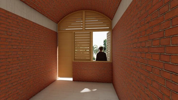 Un hombre mira por una ventana en un edificio de ladrillo.