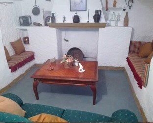 Una sala de estar con sofá, mesa de café y chimenea.