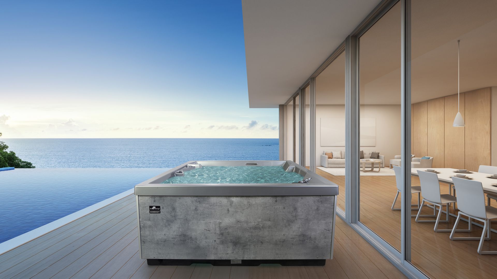 Una grande vasca idromassaggio su un balcone con vista sull'oceano