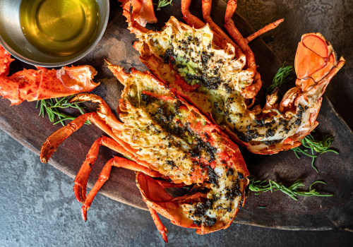 Sign welcoming visitors to Marathon, Florida, with road, blue sky, and trees.