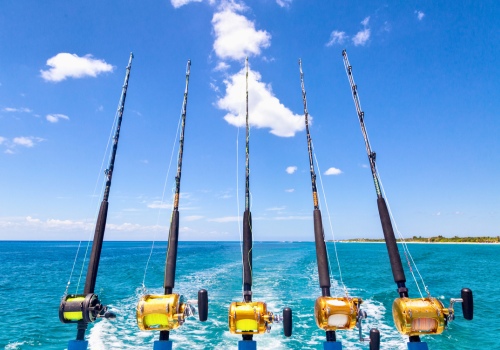 Fishing rods rigged on a boat, blue ocean and sky, sunny day in the florida keys