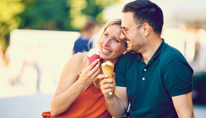 Couple laughing and eating ice cream cones outdoors in the florida keys