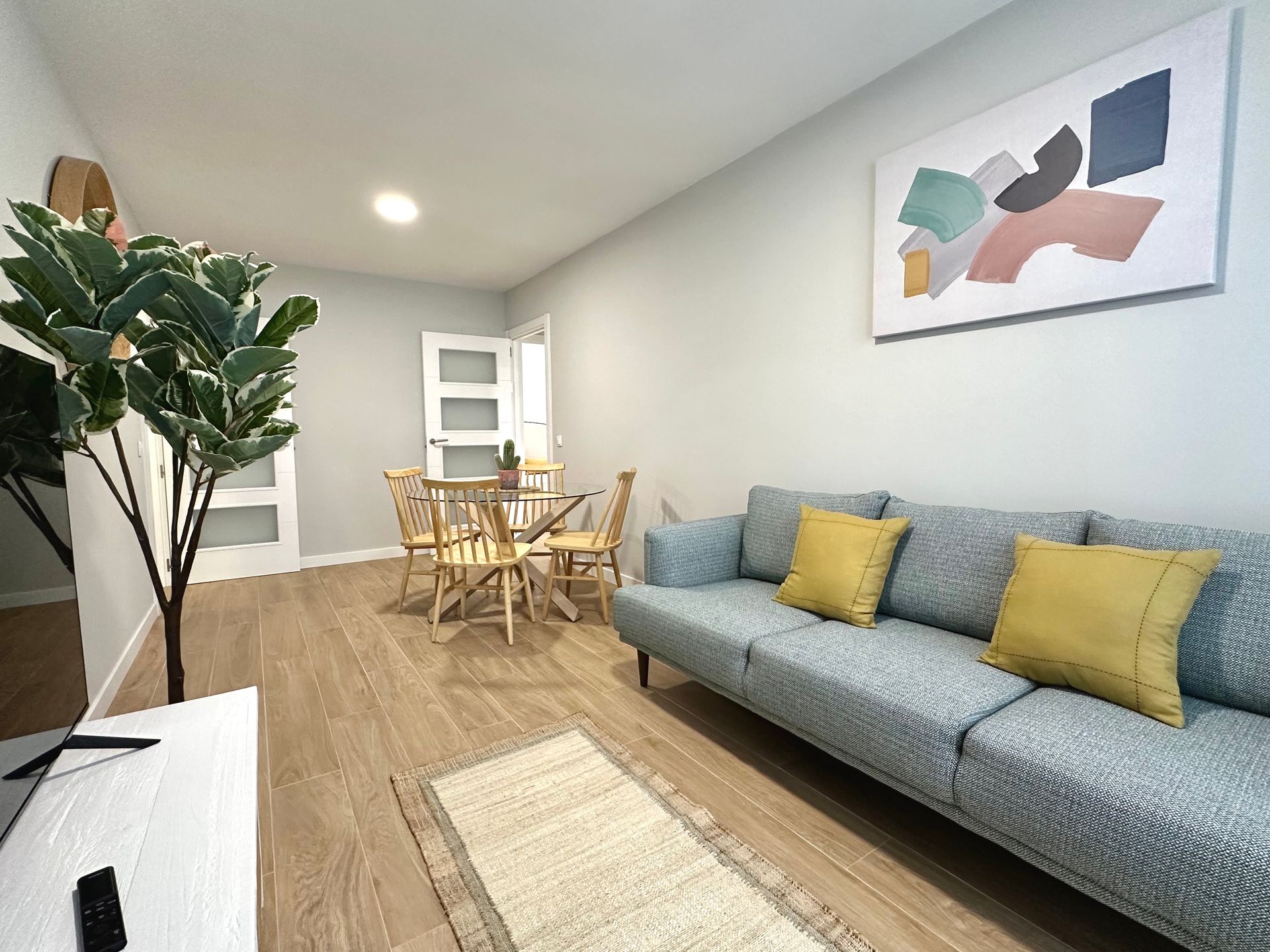 A modern living room with a couch , table and chairs.