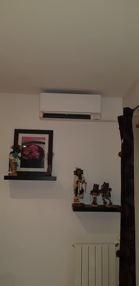 Climatisation au dessus d'étagères dans une pièce de vie