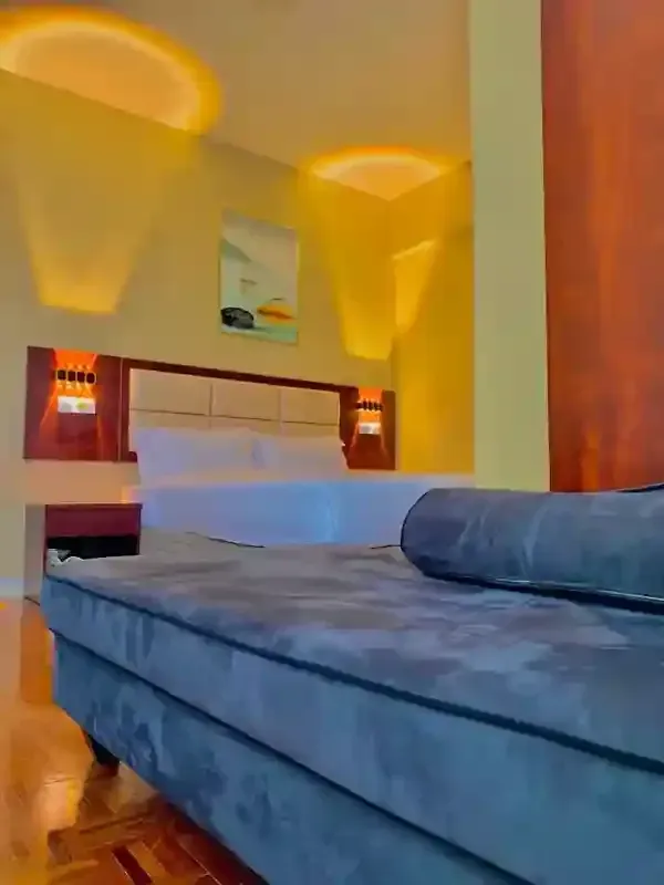A hotel room with a bed and a couch