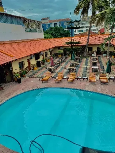 An aerial view of a large swimming pool surrounded by chairs and tables.