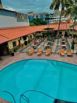 An aerial view of a large swimming pool surrounded by chairs and tables.