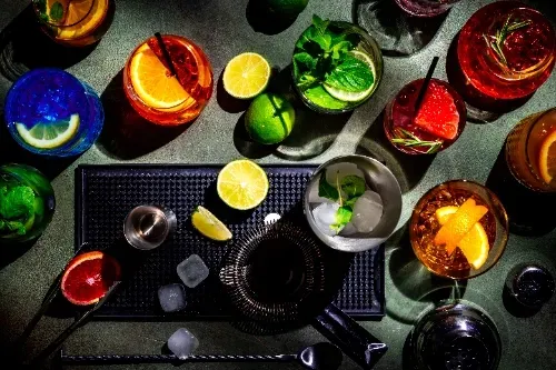 There are many different types of drinks on the table.