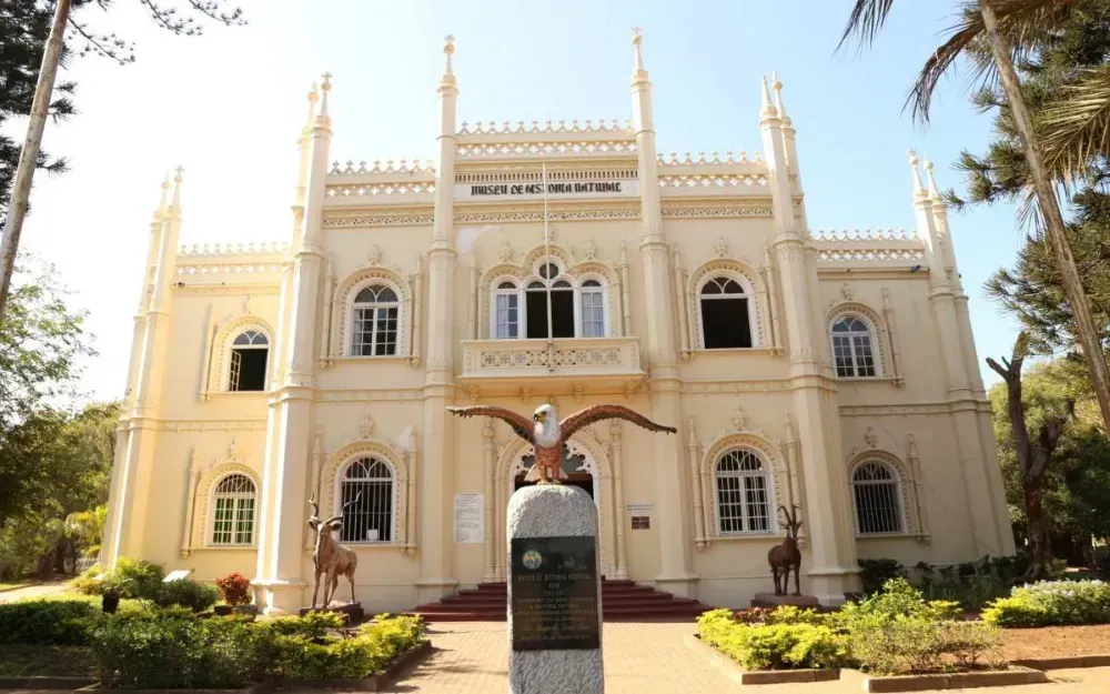A large white building with a statue of an eagle in front of it.