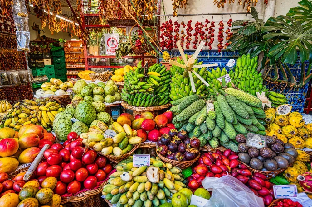 A variety of fruits and vegetables are on display at a market.